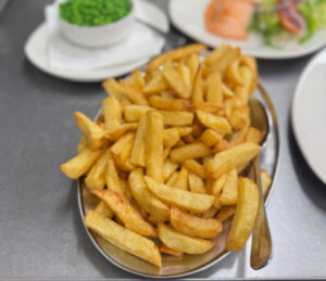 Tray of freshly cooked golden handcut chip shop chips